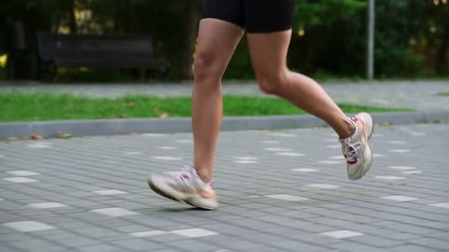 Closeup of Female Athlete's Feet Running at the Park