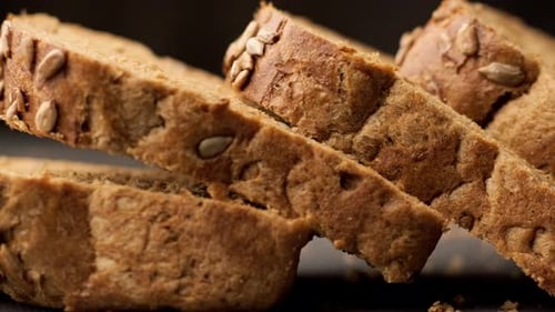 Cutted Slices of Bread. Close-up View of Brown Organic Bread. Panning Shot