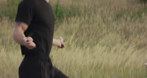 Muscular Man Skipping Rope Outdoors on Path