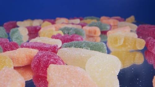 Vibrant Gummy Candies Displayed on Reflective Surface