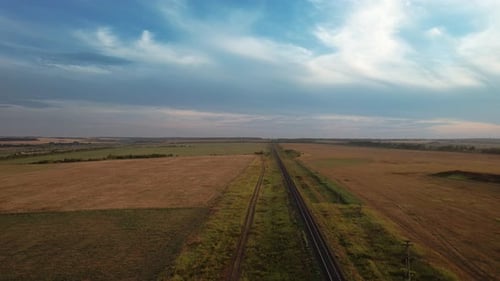 Rural Railway Track Cuts Through Countryside Landscape