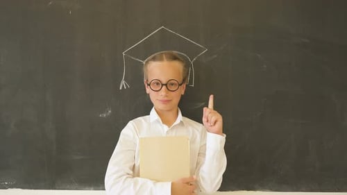 Girl with Graduation Cap Drawn on Chalkboard