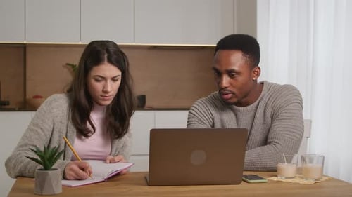 African American Tutor is Helping Caucasian Woman Student to Prepare to Pass Exam Learning at Home