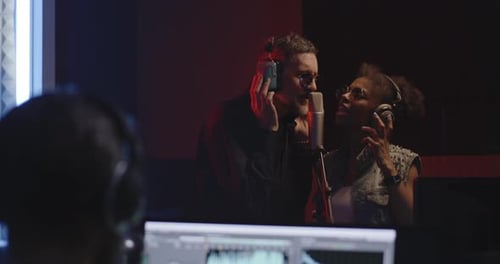 Singers and Sound Engineer Working in Studio