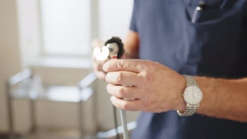 Surgeon Inspects Endoscope Surgical Instrument in Hospital Setting