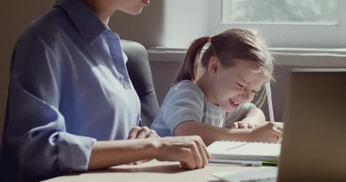 Child Daughter and Mum Sitting at Table Together, Study at Home, Girl Tired of Doing Homework