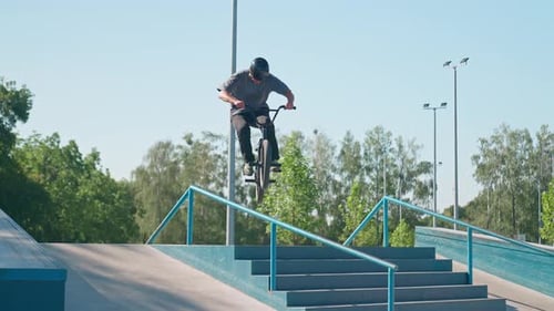 Young Adult Riding BMX Bike at Skatepark