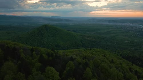 Aerial View of Dark Mountain Hills Covered with Green Mixed Pine and Lush Forest in Evening