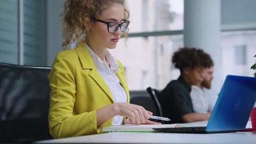 Businesswoman Making Schedule in Office