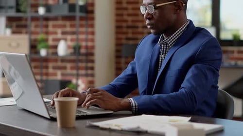 Man Working on Laptop in Office