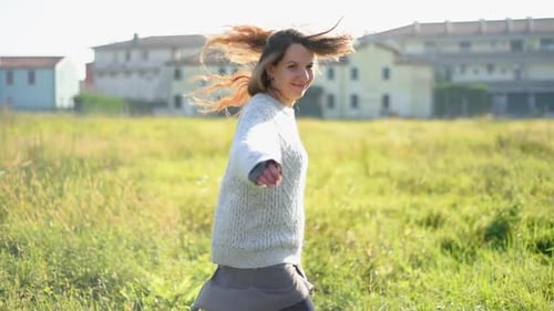 Spinning around in meadow