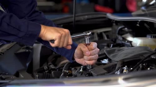 mechanic hand using wrench to repair engine, car service