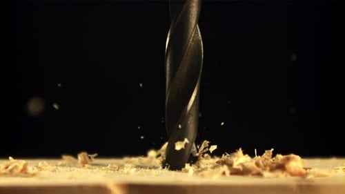 Drill Bit Drilling Wood with Chips Flying