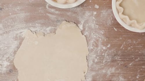 Hands Rolling Out Dough for Homemade Pies