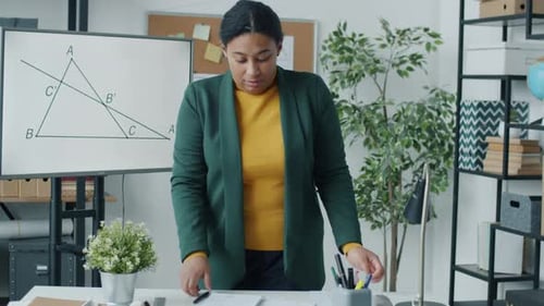 Portrait of Online School Teacher Explaining Maths Working Indoors Speaking and Looking at Camera