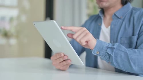 Close Up of Hand Working on Digital Tablet