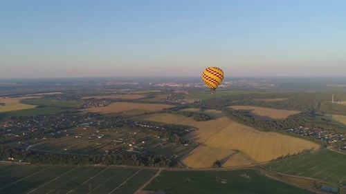 Hot Air Balloon Over Green Rural Landscape