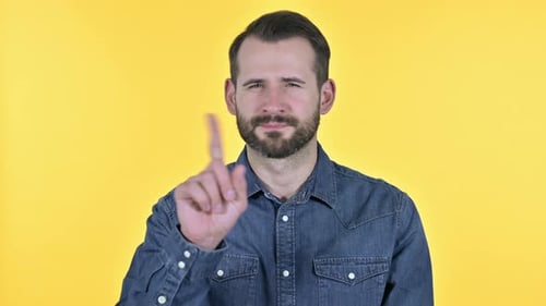 Man Shakes Head and Raises Finger to Say No