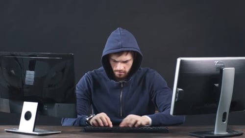 IT Professional Programmer Is Working on Computer in Dark Office Room