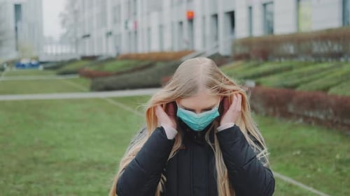 Woman Wearing Surgical Mask Outside on Overcast Day