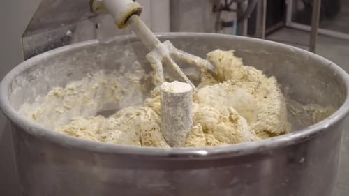 Industrial mixer for kneading dough. Mixing equipment in bakery.