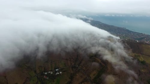 Rolling Cloud Cover Across Mountains From Drone