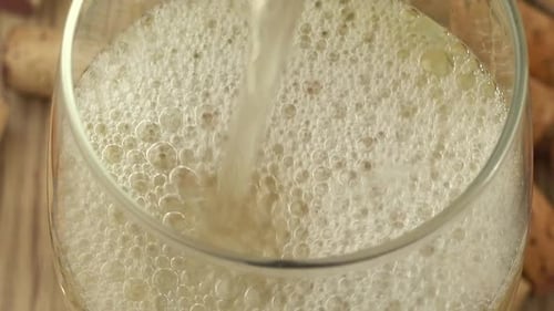 Pouring White Wine in Wine Glass Close Up