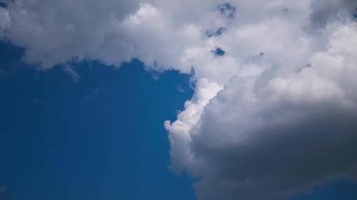 White Clouds Drifting Across Blue Sky