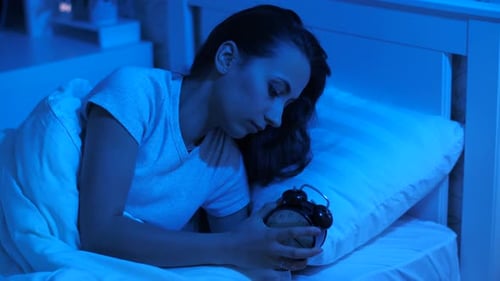 Woman Sets Analog Clock and Goes to Sleep