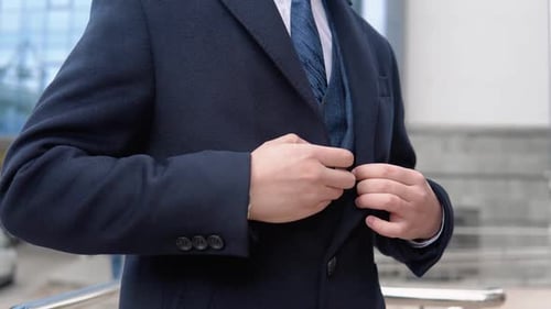 Man in Navy Coat Buttoning His Coat