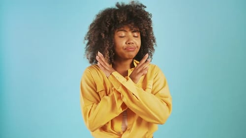 Darkskinned Female Showing Stop Sign By Crossed Hands Saying No and Gesturing It By Forefinger