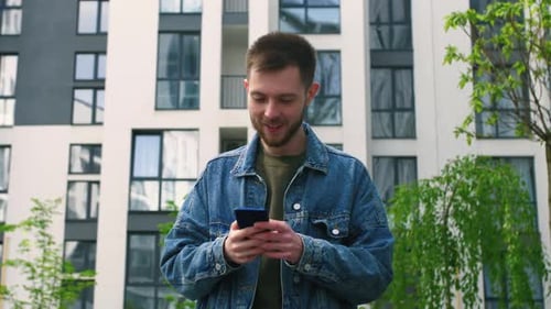 Bearded Handsome Man Having a Slow Walk in the Town