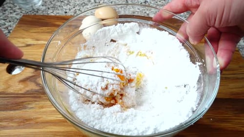 Hand Mixing Powder with Whisk in Bowl