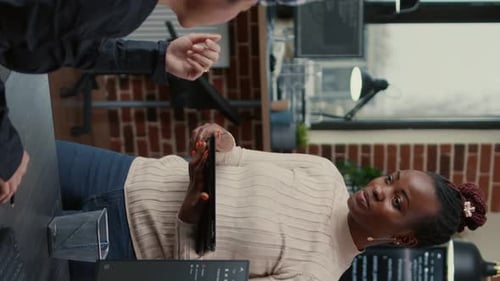 Colleagues Reviewing Data on Tablet Together