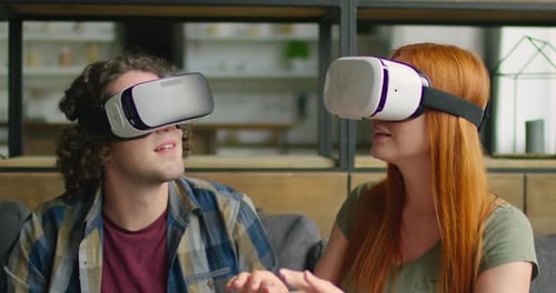 Couple Experiencing Virtual Reality with VR Headsets at Home