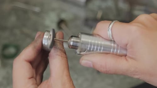 Close Up of Jeweler Buffing Silver Ring
