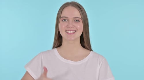 Young Woman Smiling with Thumbs Up Gesture