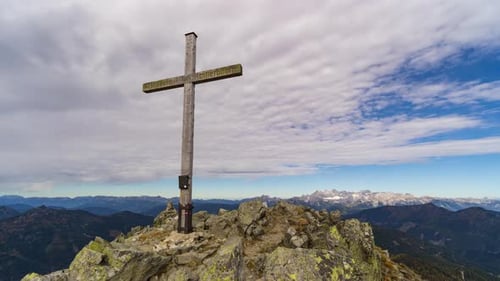 Time Lapse Clouds Pass Over Mountain Summit Cross