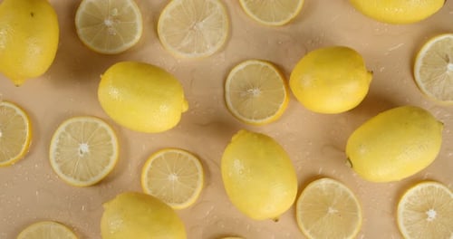 Fresh Lemons and Slices on Wet Surface