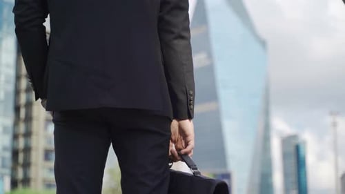 Young Adult in Suit Stands in City