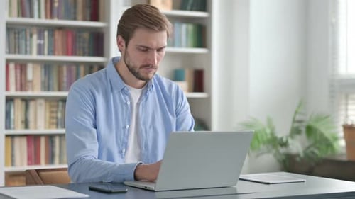 Man Working on Laptop in Office