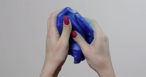 Woman Hands Playing with Oddly Satisfying Blue Slime Gooey Substance
