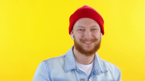 Man with Red Beanie Dancing on Yellow Background