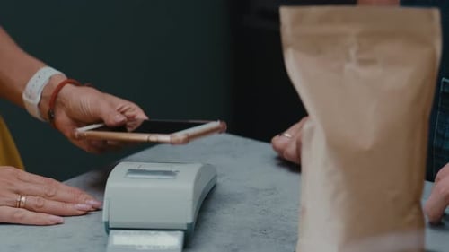 Customer Making Mobile Payment in Store