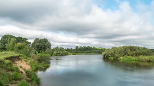 Clouds reflected in the smooth water of a river.