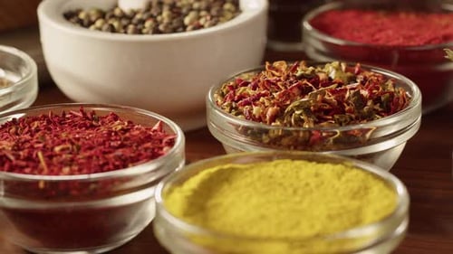 Colorful Spices and Herbs in Glass Bowls