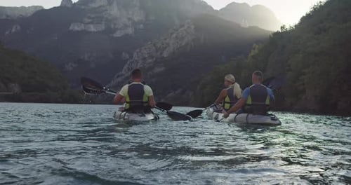 Kayaking on Lake Surrounded by Majestic Mountains
