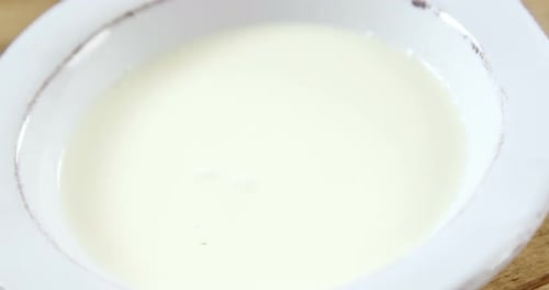 Strawberry falling in whipped cream