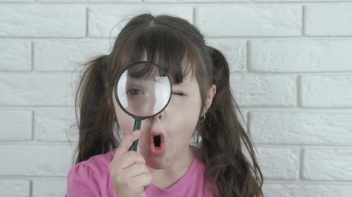 Child with a magnifier.