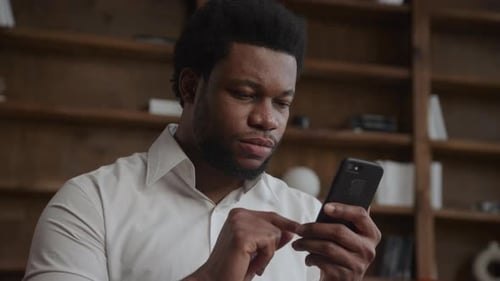 Portrait of an Adult Man Browsing on His Smartphone